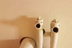 picture of two pipes with eyes stuck on to make them look like creatures