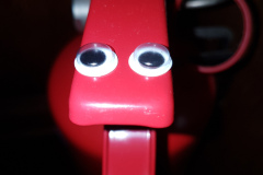 Fire extinguisher with eyes stuck on to make it look like some kind of dog