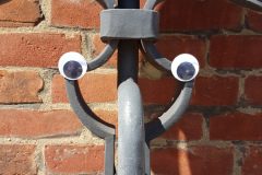 Roadsign stand with eyes stuck on to give it a face