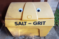 Bin for road salt with eyes stuck on so it looks like some kind of robot