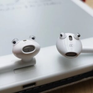 Two ear buds with eyes stuck on them so they look like little critters
